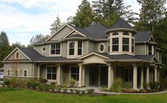 a large house with lots of windows in the front yard