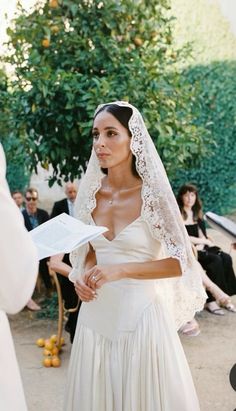 a woman in a wedding dress holding a book