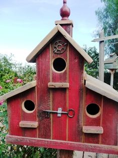 a bird house made out of wood with holes in the roof