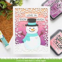 the snowman card is next to some crafting supplies