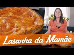 a woman sitting in front of a pizza on top of a counter next to a pie