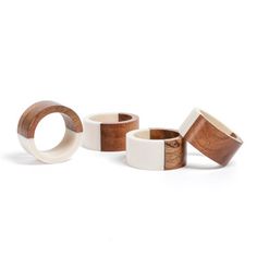 three wooden rings with white and brown wood inlays on the sides, one is made out of two different types of wood