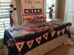 a table set up with cupcakes and desserts for a cheer team party