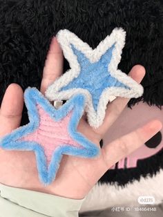 two handmade stars are held in front of a stuffed animal