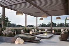 an outdoor living area with couches, tables and fire pit on the roof terrace