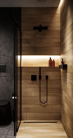 a bathroom with wooden walls and flooring is lit by recessed lighting on the wall