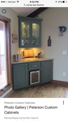 a kitchen with gray cabinets and wooden floors is featured on the website for custom cabinetry