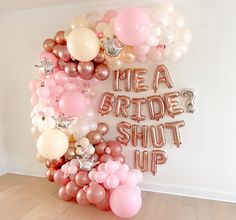 a bunch of balloons that say mea bride's shut up on the wall