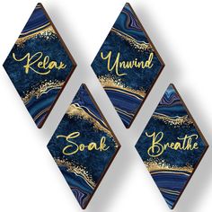 three blue and gold acrylic diamond shaped plaques with words that say,'relax, yumink, soak, breathe '