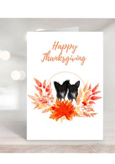 a thanksgiving card with two black dogs on top of leaves and the words happy thanksgiving