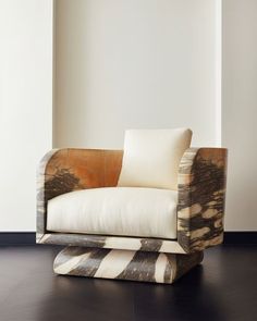 a chair that is sitting in the middle of a room with black and white flooring