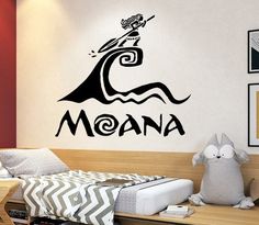 a room with a bed and wall decal that says moana on the side