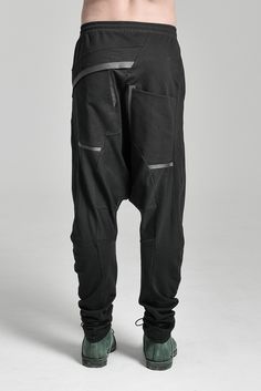 "DISTORTED BLACK DROPPED CROTCH TRACK PANTS WITH ELASTIC WAISTBAND __ELASTIC WAISTBAND WITH DRAWSTRING __J SHAPED LEGS __2 FRONT POCKETS __2 REAR BONDED POCKETS __ASYMMETRICAL HIDDEN FRONT CLOSURE model__ chest 103 (40.5\"), waist 77 (30.3\"), hips 96 (37.8\"), biceps 35 (13.8''), height 180 (5'11\"), kg 74 (163 lbs) wears size S color: black with black matte tape fabric__ 100 cotton care__ delicate machine wash at 30 c wash inside out use cool iron do not tumble dry sizing__ size XS (IT 44, US Black Fitted Drop Crotch Bottoms, Low Crotch Pants, Track Pants Mens, Cropped Linen Pants, Wool Pants, Black Linen, Cotton Pants, Pants Black, Linen Pants