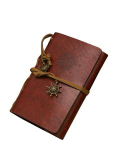 a brown leather book with a compass and rope on the cover is shown in full color