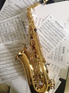 a saxophone sitting on top of sheet music