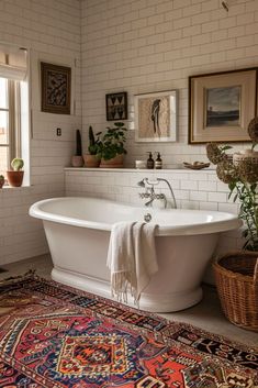 a white bath tub sitting on top of a rug next to a window