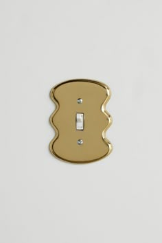 a single light switch cover in gold