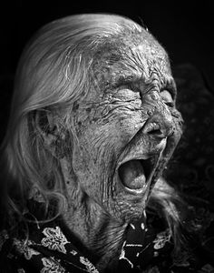 an old woman with her mouth open and it's eyes wide open, showing the teeth