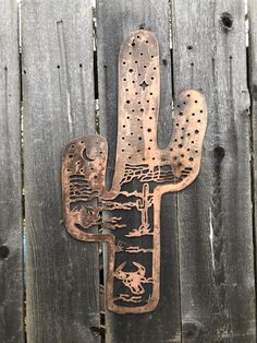 a metal cactus on top of a wooden fence