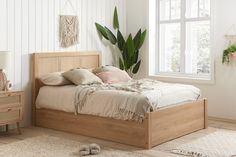 a bedroom with white walls and wooden furniture