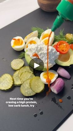 an egg being drizzled with mayonnaise next to sliced vegetables