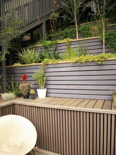 an outdoor deck with potted plants on it