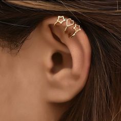 a close up of a person's ear with two small gold stars on it