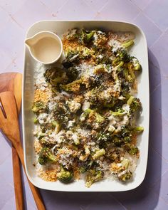 a casserole dish with broccoli covered in cheese and parmesan