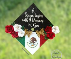 a graduation cap decorated with flowers and the words, a dream begins with a dreaming 1st gen