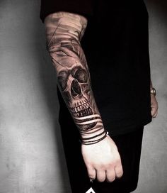 a man with a skull tattoo on his arm