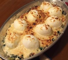 a pan filled with eggs on top of a wooden table