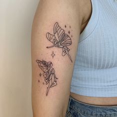 a woman with a tattoo on her arm has two small fairy tattoos on her arms