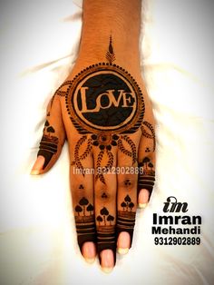 a hand with the word love painted on it and an image of a circle in the middle