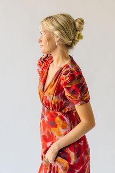 The Fannon Floral Midi Dress in Red Multi is sure to turn heads with its vibrant colors and playful floral pattern. With a comfortable and flattering midi length, this dress is perfect for any occasion. Bring a touch of whimsy to your wardrobe with this one-of-a-kind dress. Details self/lining: 100% polyester Fabric Care Guide Here Sizing & Fit Measurements are approximate and taken while laying flat across the front. Not doubled. small: bust = 18"; length = 48" medium: bust = 19"; length = 48.5 Fitted Red Midi Dress With Vibrant Print, Red Floral Print Knee-length Dress, Vibrant V-neck Midi Dress For Brunch, Vibrant Red Fitted Midi Dress, Fitted Red Floral Dress For Spring, Red Knee-length Dress With Floral Print, Vibrant Floral Print Midi Dress, Red Midi Dress With Vibrant Print, Vibrant Red Floral Print Maxi Dress