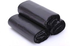 two rolls of black tarp sitting on top of each other in front of a white background