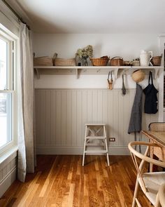 a kitchen with wooden floors and white walls