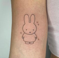 a small rabbit tattoo on the right arm and leg, with stars in the background