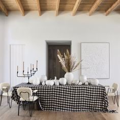 a black and white checkered table cloth on a dining room table surrounded by chairs