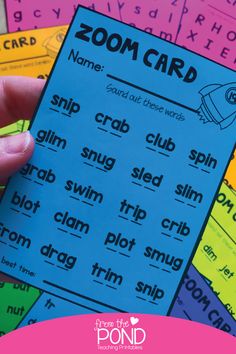 a hand holding up a zoom card in front of some other cards with words