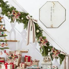 christmas decorations and presents under the banister