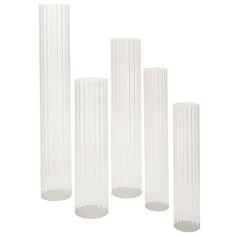 four tall white vases sitting next to each other