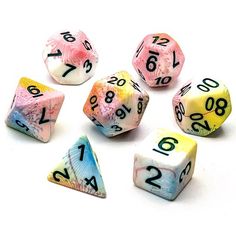 seven different colored dice with numbers on them