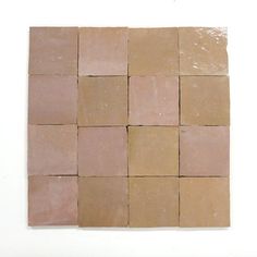 several square tiles are arranged on the wall