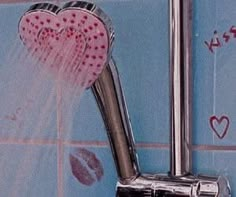 a shower head with two hearts attached to it