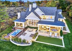 an aerial view of a large house with a pool and hot tub in the yard