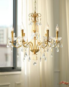 a chandelier hanging in front of a window