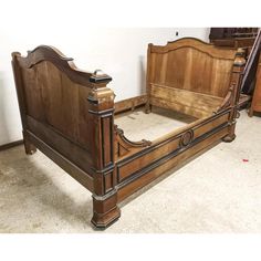 an antique wooden bed frame in a room