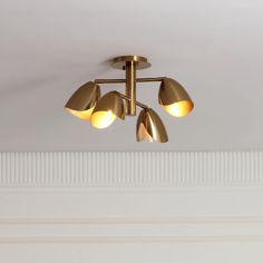 three lights are hanging from the ceiling in a room with white walls and flooring