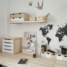 a desk with some drawers and a world map on the wall