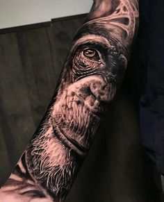 a man's arm with an image of a monkey on it and his eyes open